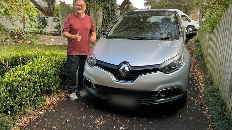 A person beside a car outdoors