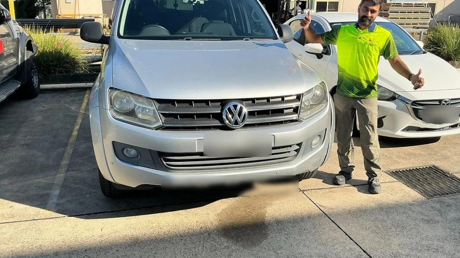 A person standing beside a vehicle